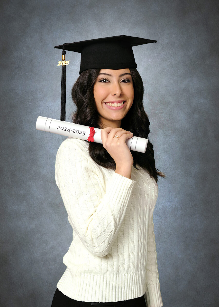 A High School Graduation Portrait of a girl wearing a graduation cap holding a diploma over her shoulder. This pose is from Studio NanC's Deluxe Graduation Session.