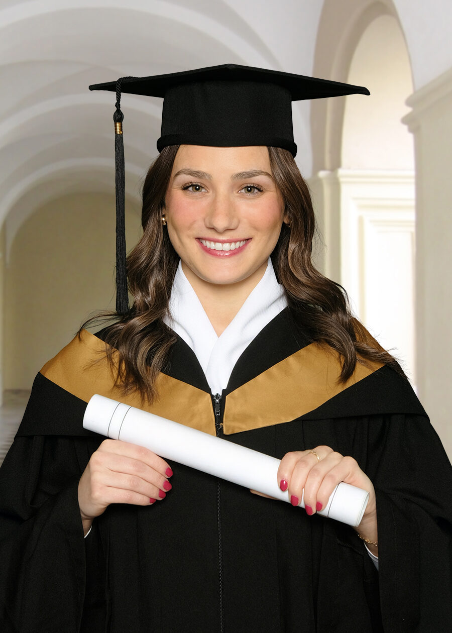 University portrait of a young woman smiling wearnig a graduation cap and gown, holding a diploma